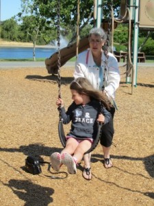 Dena pushing Camryn on the swing